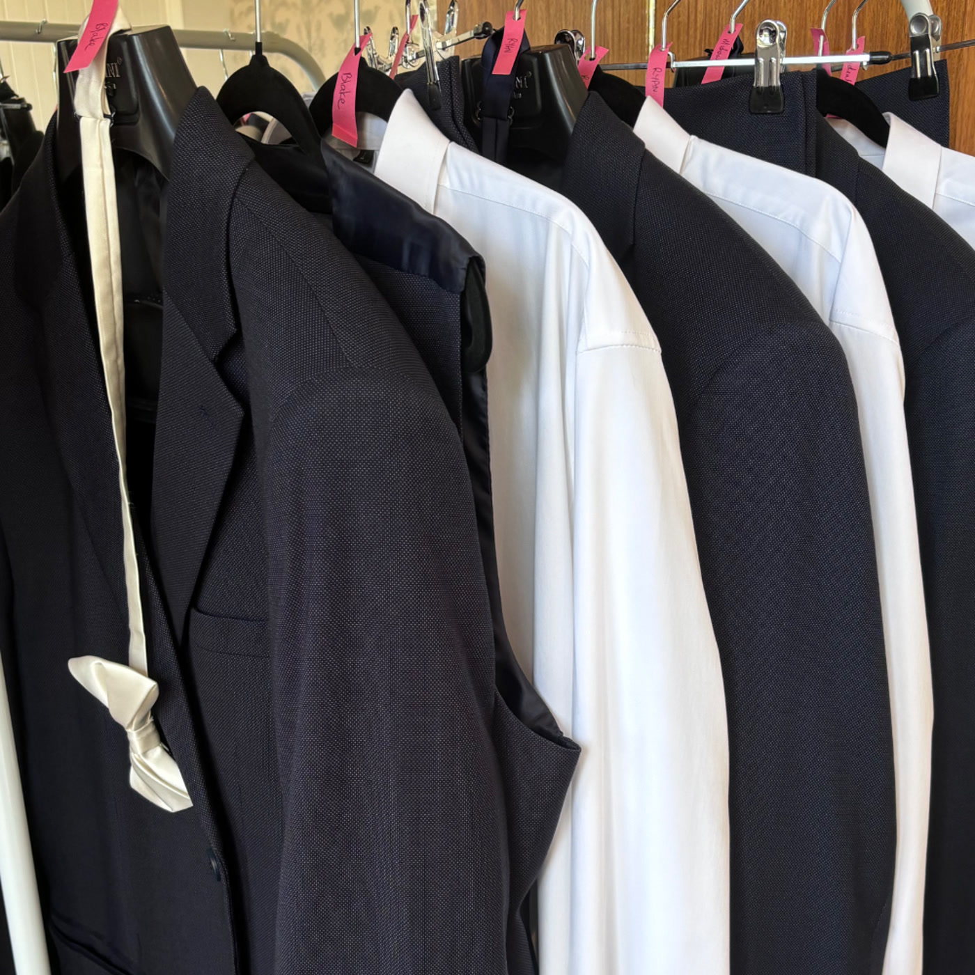 Formalwear on hangers ready for professional wedding day steaming by Alterations by Jacqui