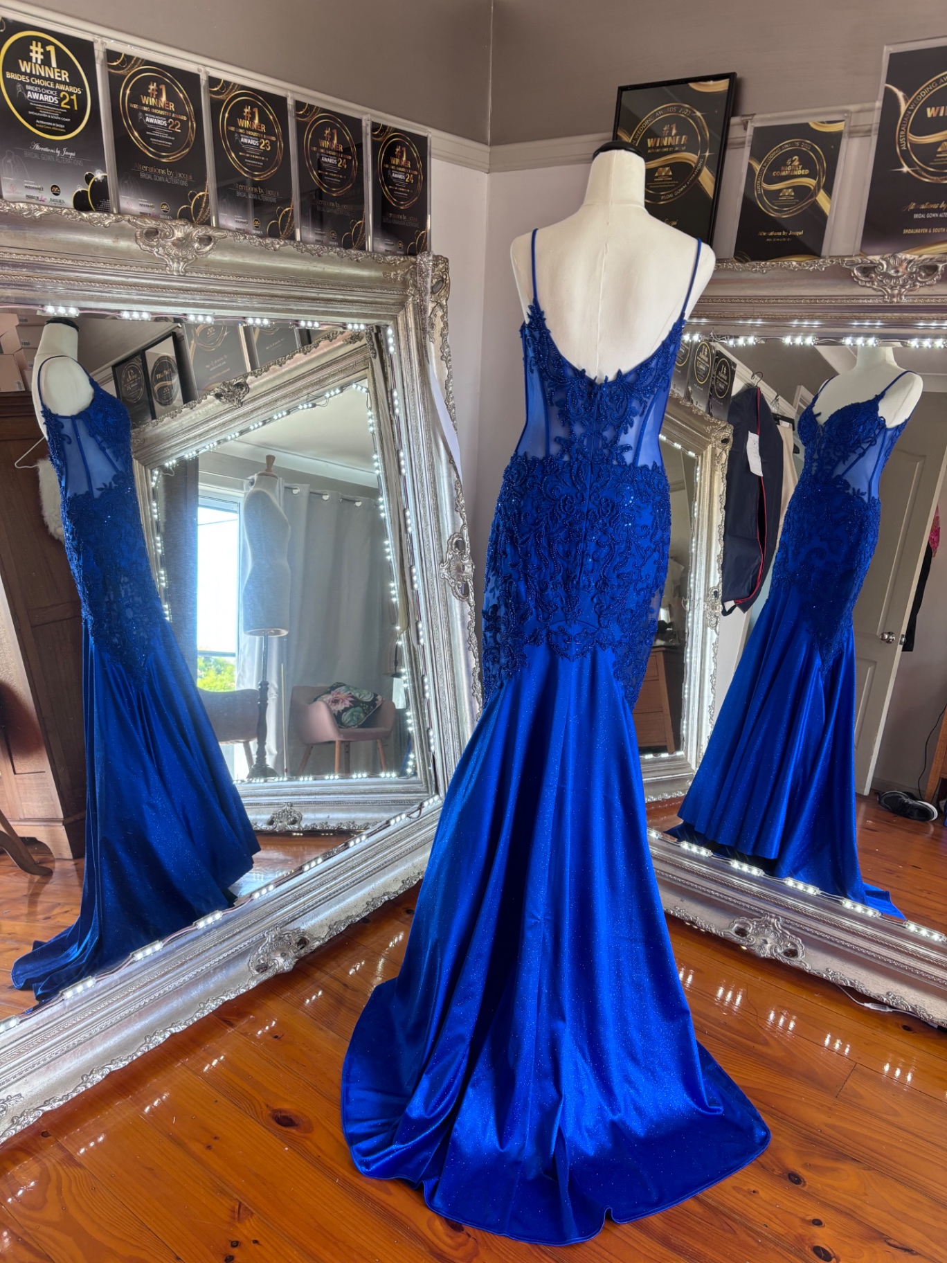 Royal blue formal gown with beaded lace bodice and fitted mermaid silhouette on a mannequin after formal dress alterations and resizing