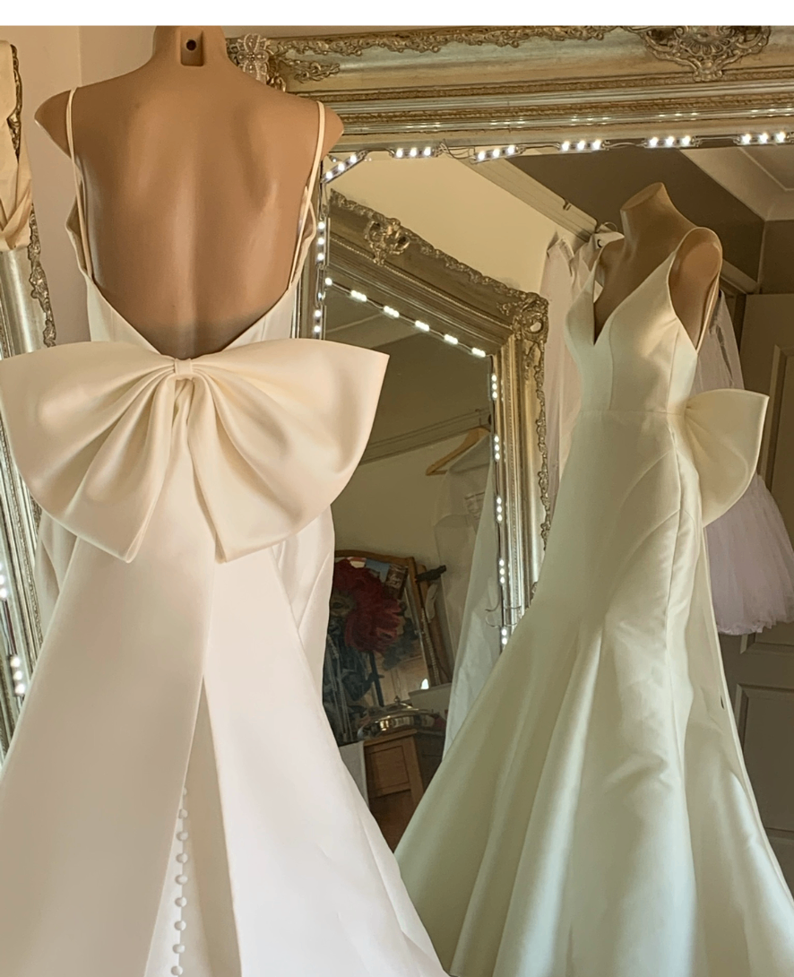 Open-back ivory mermaid wedding gown with oversized statement bow at the back — gown reconstruction and bodice alterations by Jacqui