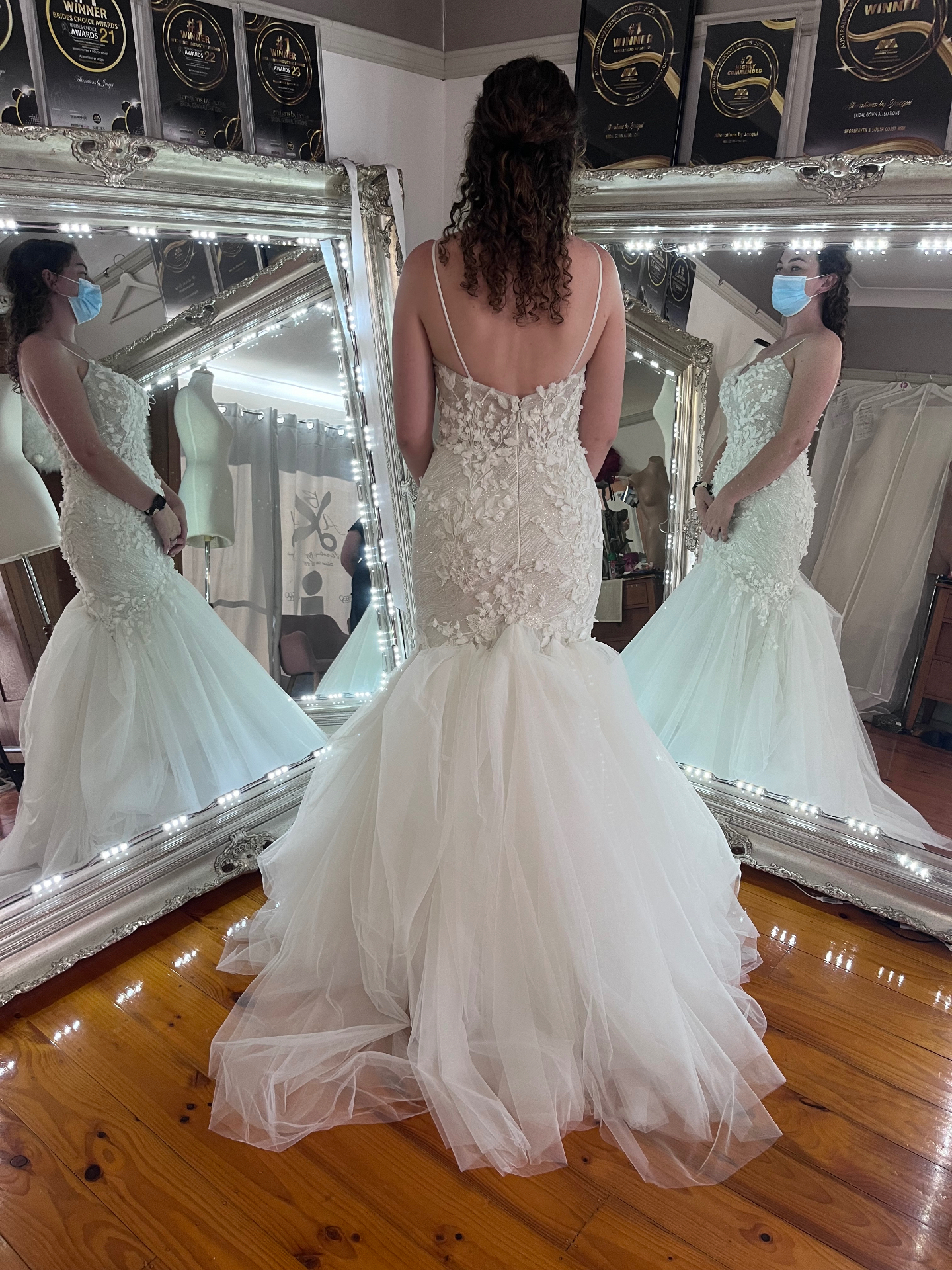 Bride in a 3D floral lace bodice mermaid wedding gown with layered tulle skirt — skirt layering, hemming, resizing and custom bustle by Jacqui